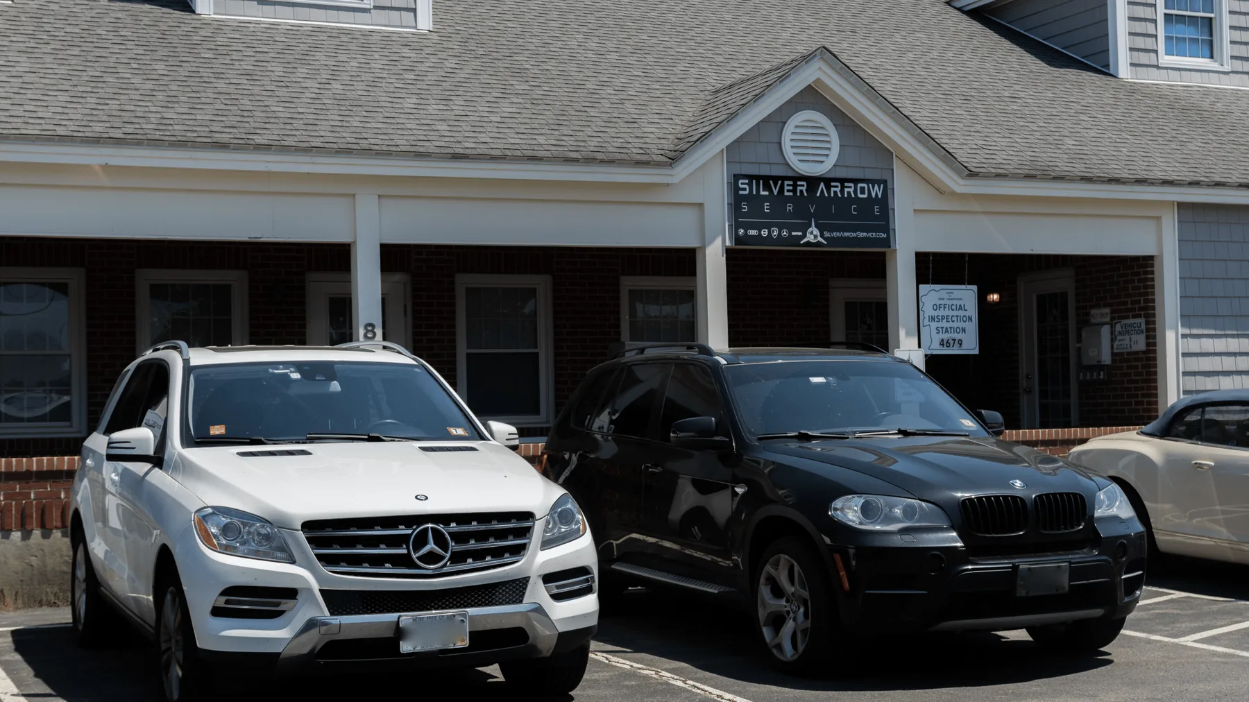 A BMW X5 and a Mercedes-Benz ML parked outside Silver Arrow Service