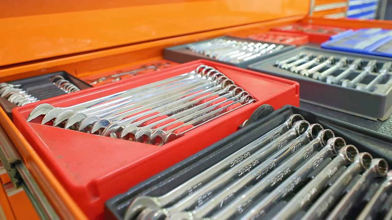 An open toolbox drawer of combination wrenches